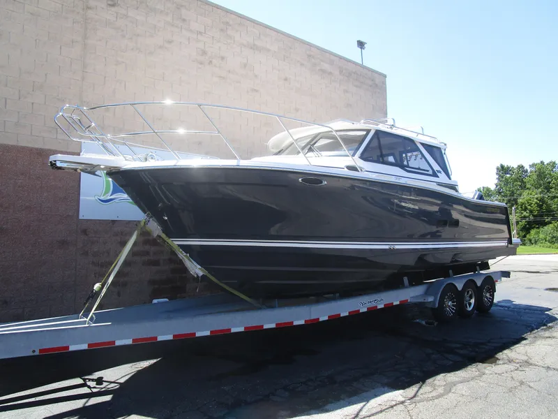 Slide: The Image of 2025 Cutwater C-288 Coupe boat on trailer, parked outdoors, side view. - 1