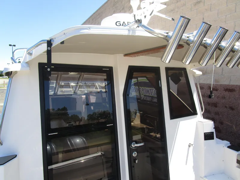 Slide: The Image of 2025 Cutwater C-288 Coupe kitchen with sink, stove, and oven in a compact design. - 20