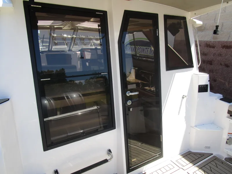 Slide: The Image of 2025 Cutwater C-288 Coupe dashboard with Garmin navigation and wooden steering wheel. - 21