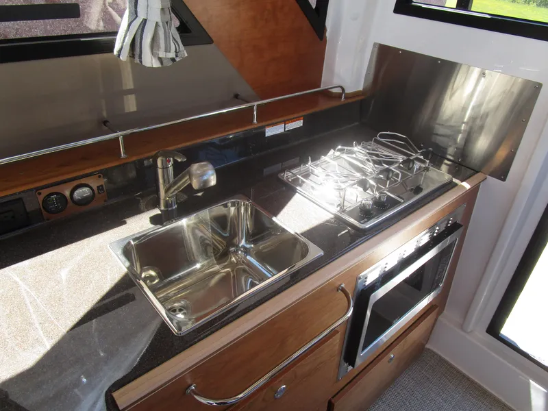 Slide: The Image of 2025 Cutwater C-288 Coupe interior with modern helm and luxurious seating. - 24