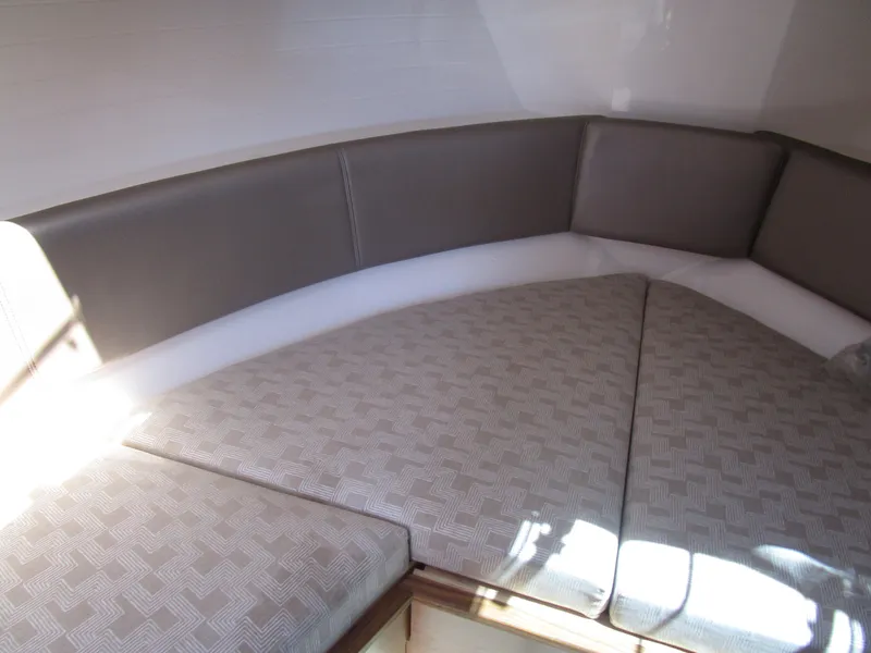 Slide: The Image of 2025 Cutwater C-288 Coupe interior with dining area and modern seating. - 27