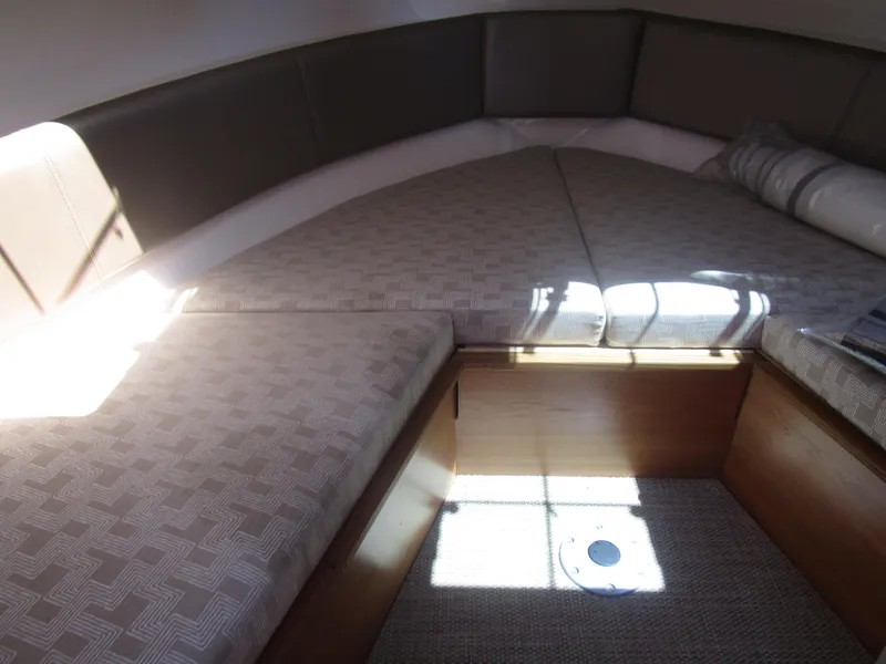 Slide: The Image of Interior seating of 2025 Cutwater C-288 Coupe with modern design and wooden table. - 28