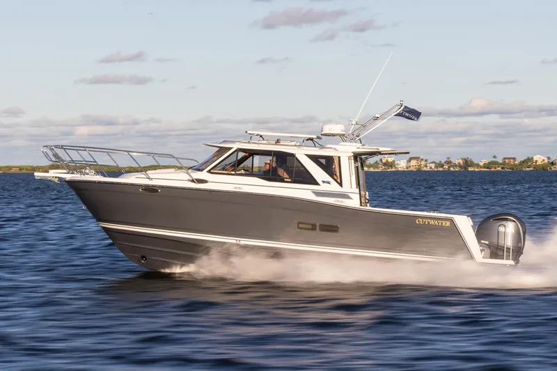 Slide: The Image of 2025 Cutwater C-288 Coupe with dual 250 V6 outboard engines, docked under clear blue sky. - 3