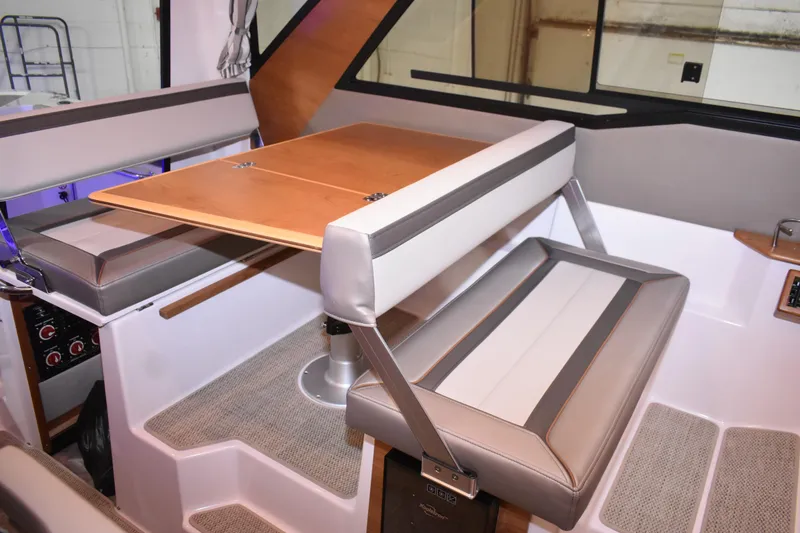 Slide: The Image of 2025 Cutwater C-288 Coupe interior with wood finish, TV, and seating area. - 33