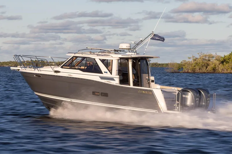 Slide: The Image of 2025 Cutwater C-288 Coupe with dual Yamaha outboard engines in a parking area. - 4