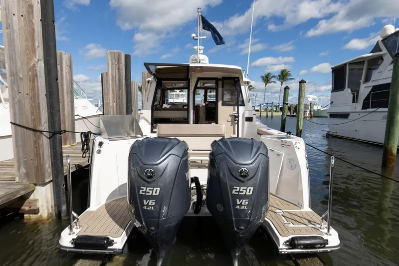 Slide: The Image of 2025 Cutwater C-288 Coupe boat interior with seating and dual engines. - 9