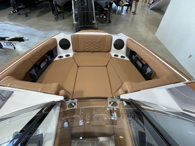 Slide: The Image of 2025 Malibu 24 MXZ boat interior with tan leather seating and modern design. - 19
