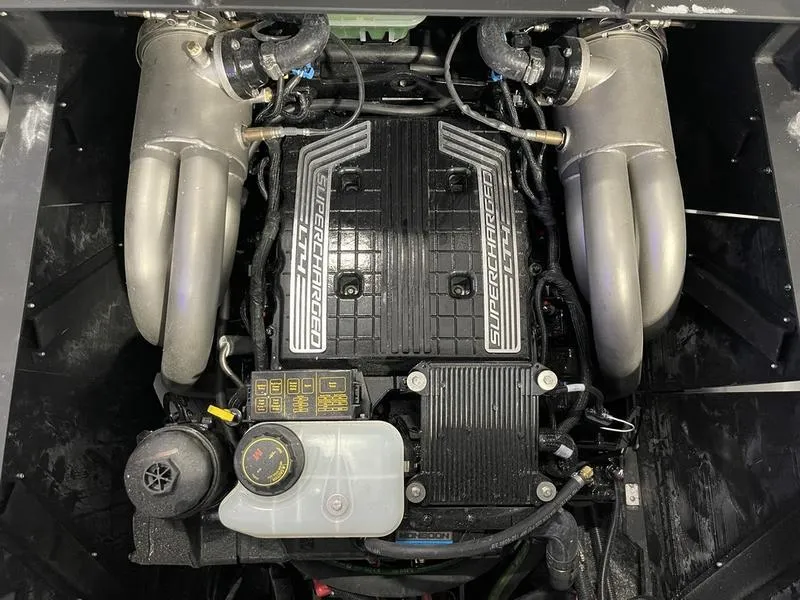 Slide: The Image of 2025 Malibu 24 MXZ engine, featuring a supercharged power unit with dual exhaust manifolds. - 28