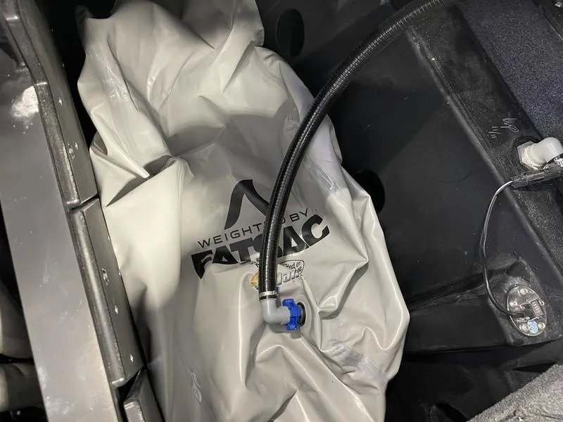 Slide: The Image of Ballast bag in 2025 Malibu 24 MXZ boat, featuring FatSac branding and hose connection. - 29