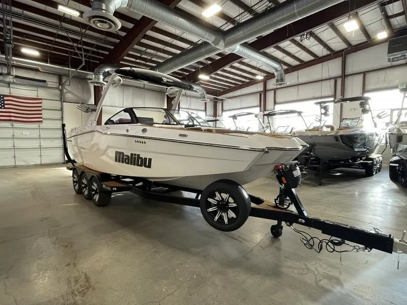 Slide: The Image of 2025 Malibu 24 MXZ boat on trailer in indoor showroom. - 5