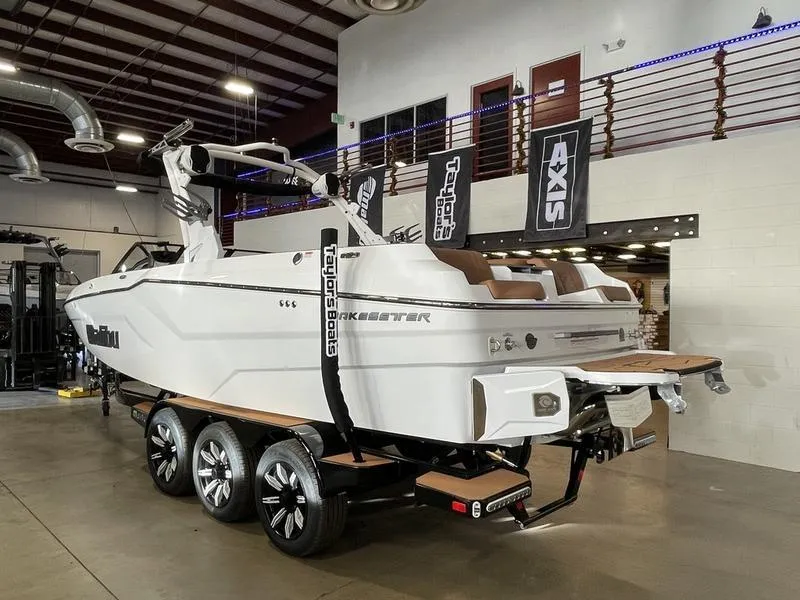 Slide: The Image of 2025 Malibu 24 MXZ boat in showroom, featuring sleek design and modern amenities. - 9