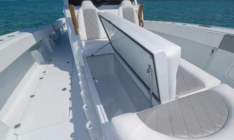 Slide: The Image of 2024 Freeman 47 boat interior with open storage compartment, featuring sleek white and gray seating. - 15