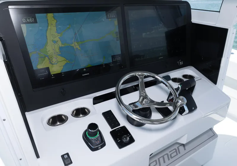 Slide: The Image of Control panel of 2024 Freeman 47 boat with navigation screens and steering wheel. - 29