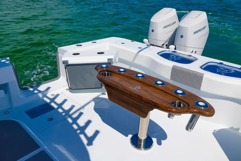 Slide: The Image of Freeman 47 boat deck with fishing rod holders and dual Mercury engines, 2024 model. - 45