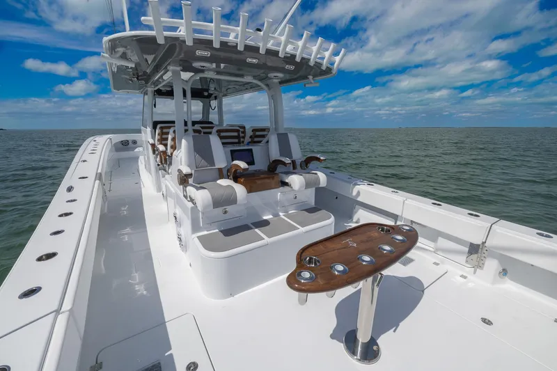 Slide: The Image of 2024 Freeman 47 boat with spacious deck and seating, cruising on open water under blue skies. - 48