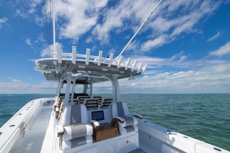 Slide: The Image of 2024 Freeman 47 boat on open water under a clear blue sky. - 49