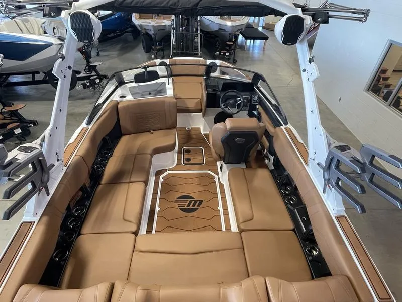 Slide: The Image of 2025 Malibu 22 MXZ boat interior with tan seating and modern design. - 12