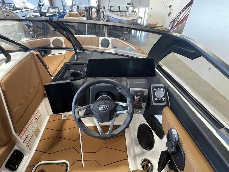 Slide: The Image of 2025 Malibu 22 MXZ boat interior with modern dashboard and steering wheel. - 17