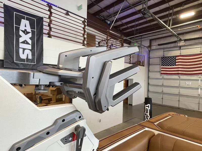 Slide: The Image of 2025 Malibu 22 MXZ boat interior with Axis wakeboard rack in a garage setting. - 21