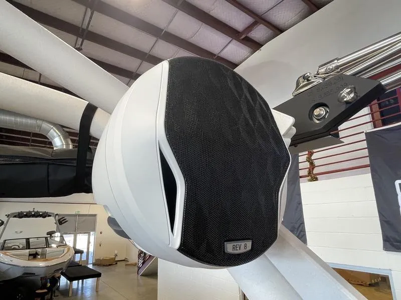 Slide: The Image of 2025 Malibu 22 MXZ boat speaker system in a showroom setting. - 22