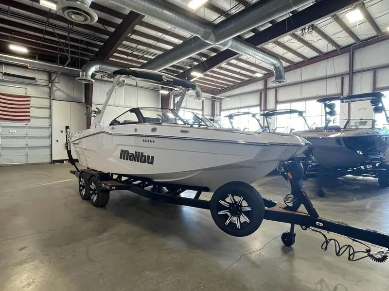 Slide: The Image of 2025 Malibu 22 MXZ boat on trailer in a warehouse setting. - 6
