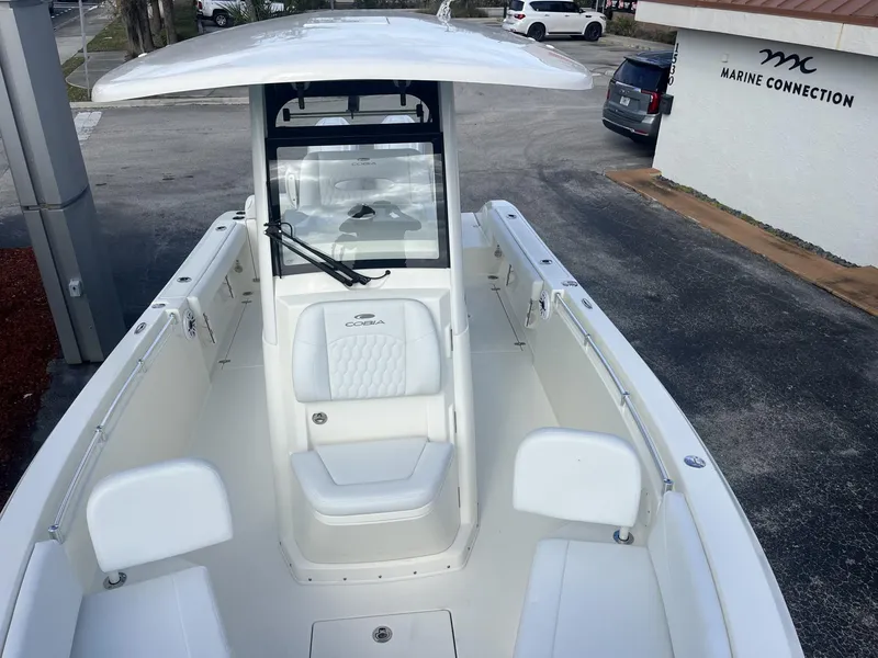 Slide: The Image of 2025 Cobia 240 CC boat at Marine Connection dealership, showcasing spacious seating and sleek design. - 21