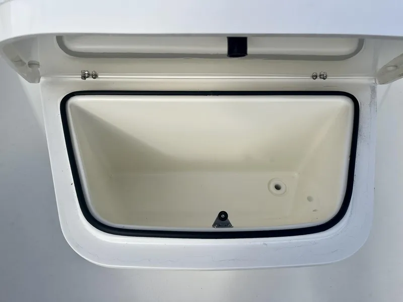 Slide: The Image of Open storage compartment on 2025 Cobia 240 CC boat. - 22