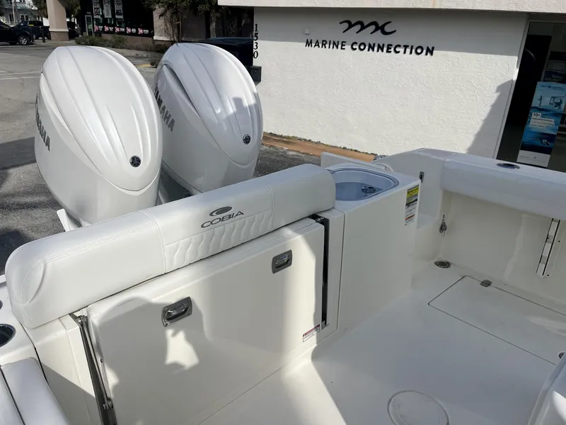 Slide: The Image of 2025 Cobia 240 CC boat with twin Yamaha engines at Marine Connection dealership. - 26