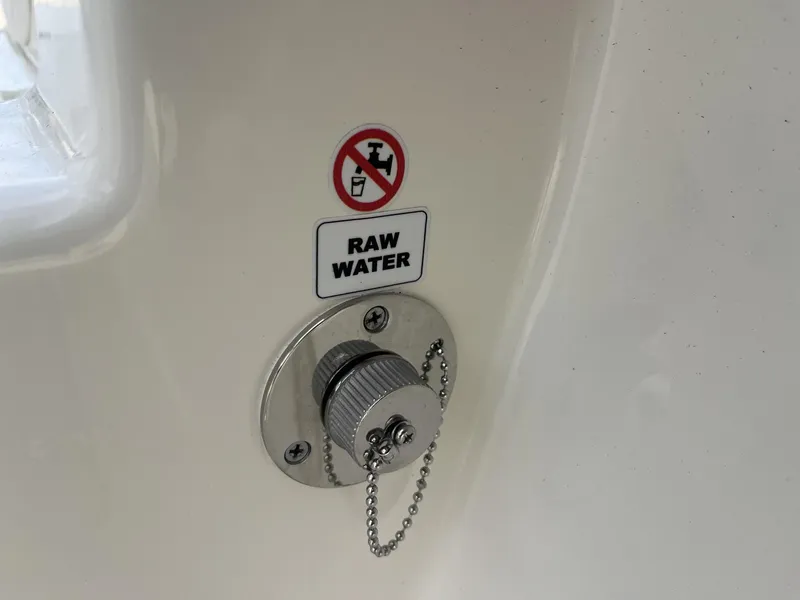 Slide: The Image of Raw water inlet on 2025 Cobia 240 CC boat, labeled with a no-drinking symbol. - 29