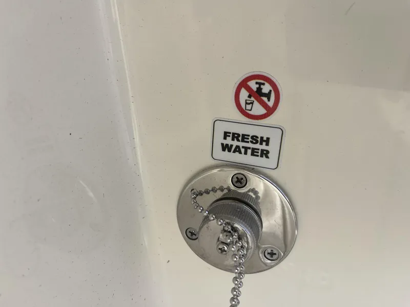 Slide: The Image of Fresh water inlet on 2025 Cobia 240 CC boat with no drinking symbol. - 30