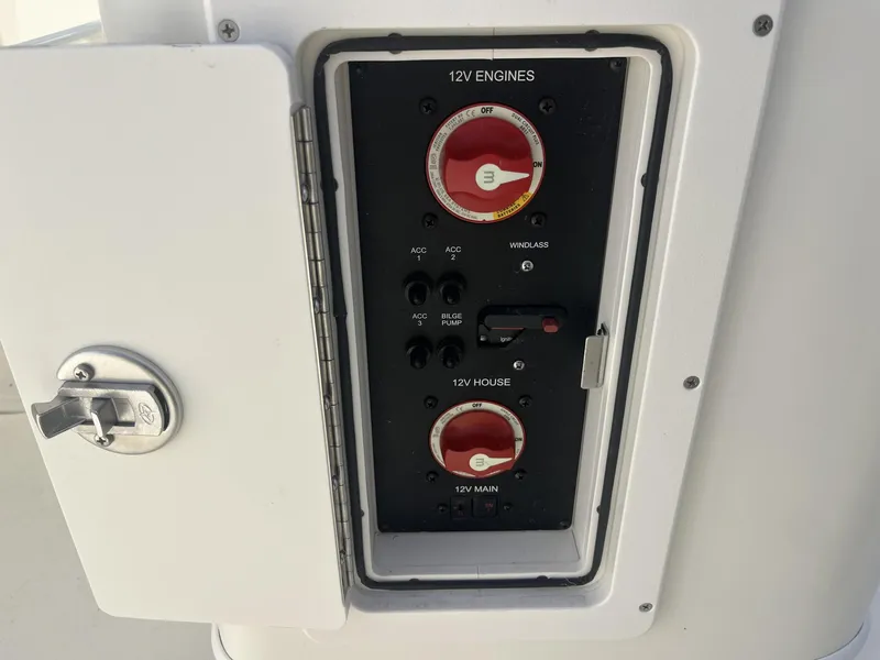 Slide: The Image of Electrical panel of a 2025 Cobia 240 CC boat with 12V engine controls. - 33