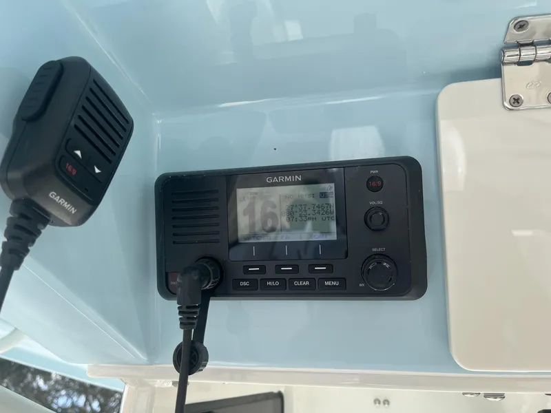 Slide: The Image of Garmin marine radio on 2025 Cobia 240 CC boat dashboard. - 16