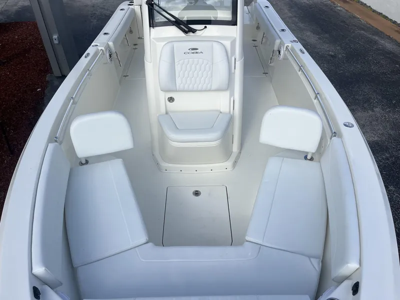 Slide: The Image of 2025 Cobia 240 CC boat interior with white seating and console. - 20