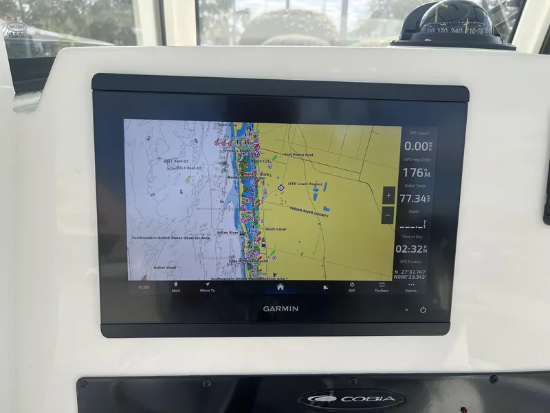 Slide: The Image of Garmin navigation display on 2025 Cobia 240 CC boat dashboard. - 14