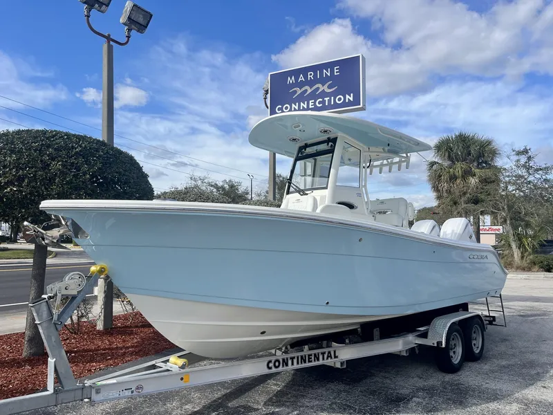 Slide: The Image of 2025 Cobia 240 CC boat on trailer at Marine Connection dealership. - 2