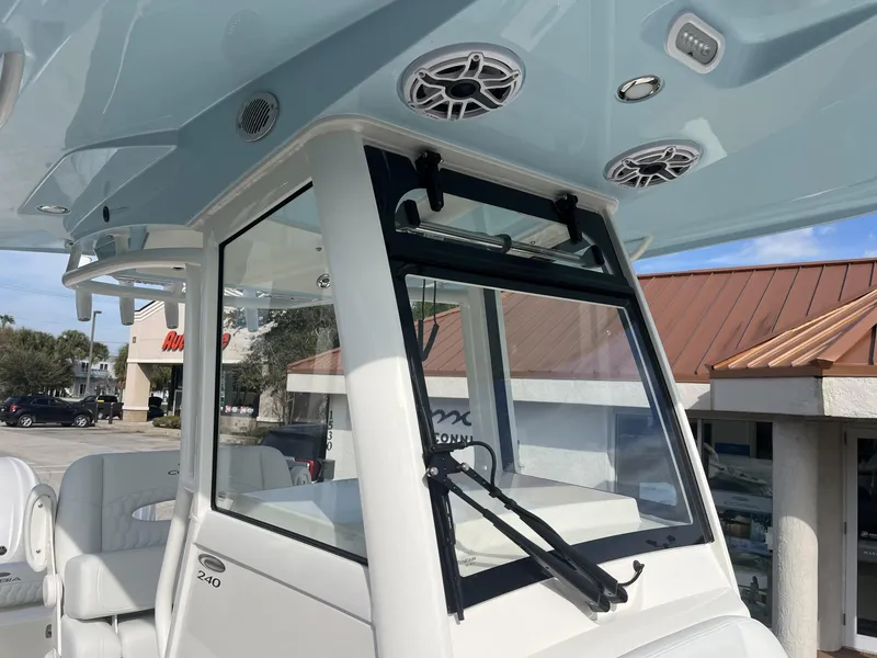 Slide: The Image of 2025 Cobia 240 CC boat interior with speakers and windshield wiper. - 24