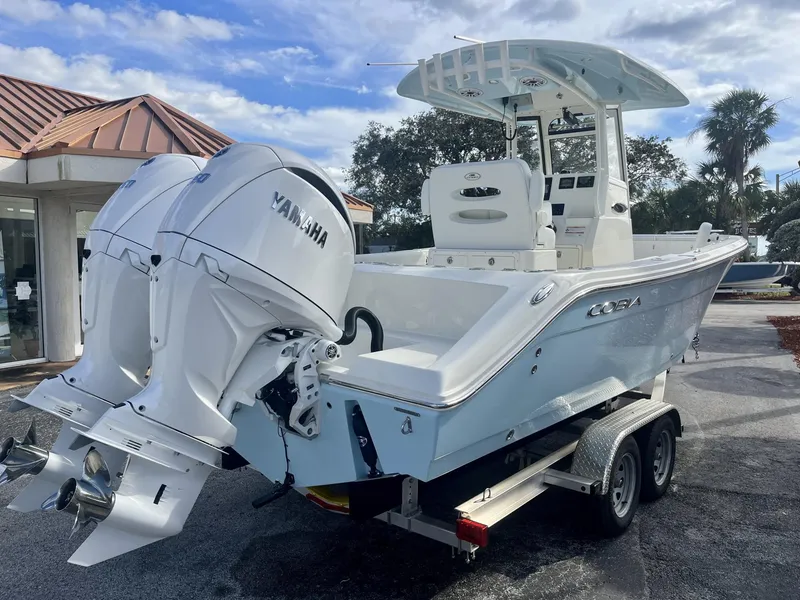 Slide: The Image of 2025 Cobia 240 CC boat with dual Yamaha engines on a trailer. - 6