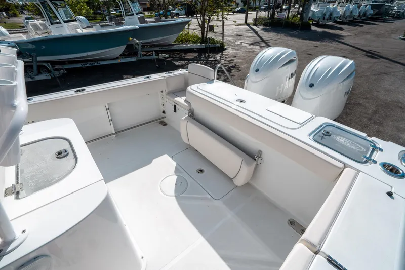 Slide: The Image of 2025 Sea Hunt GAMEFISH 27 CB boat interior with dual engines and spacious deck. - 11