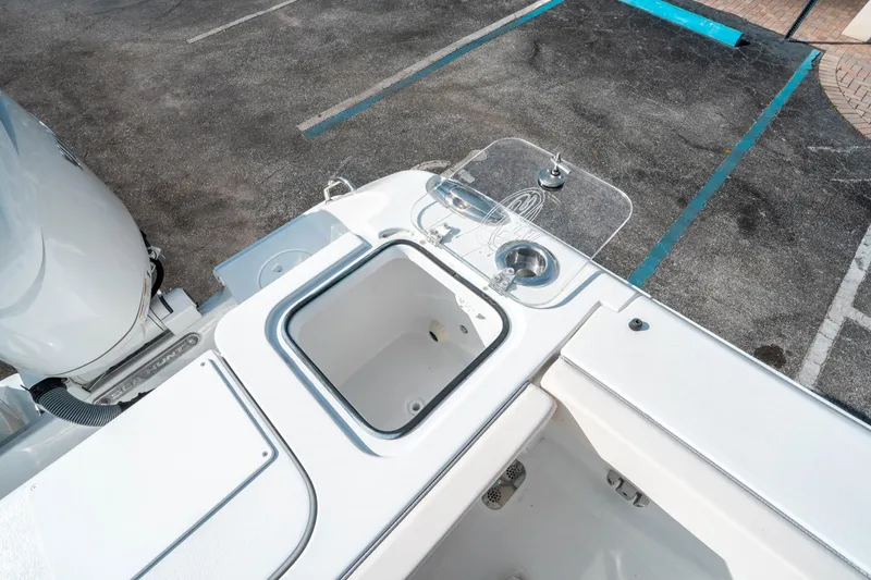 Slide: The Image of 2025 Sea Hunt GAMEFISH 27 CB boat deck with storage and sink. - 15