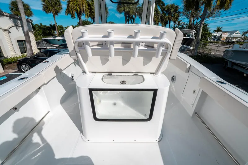 Slide: The Image of 2025 Sea Hunt GAMEFISH 27 CB boat interior with rod holders and storage compartment. - 17