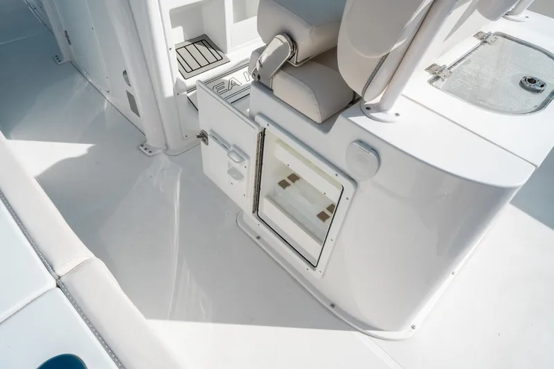Slide: The Image of 2025 Sea Hunt GAMEFISH 27 CB boat interior with seating and storage compartments. - 20