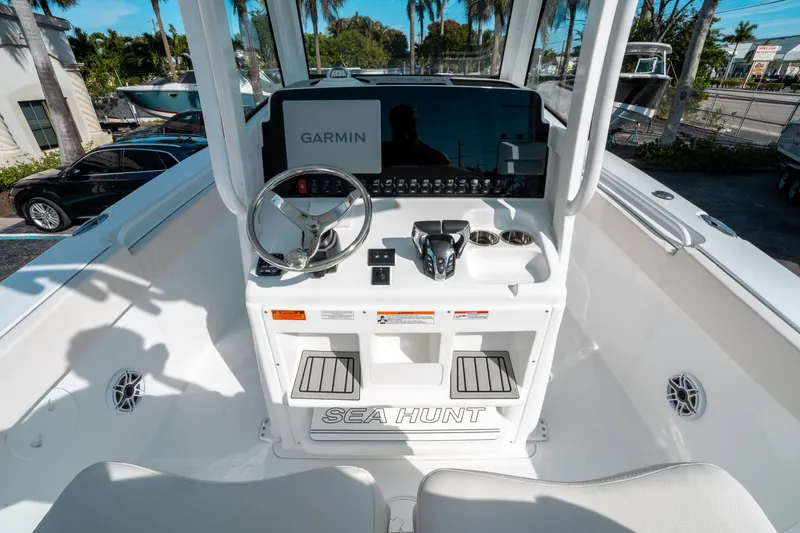 Slide: The Image of 2025 Sea Hunt GAMEFISH 27 CB boat console with Garmin display and steering wheel. - 24
