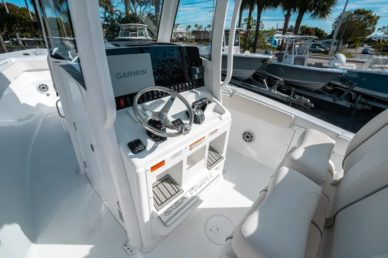 Slide: The Image of 2025 Sea Hunt GAMEFISH 27 CB boat interior with Garmin navigation system and steering console. - 26
