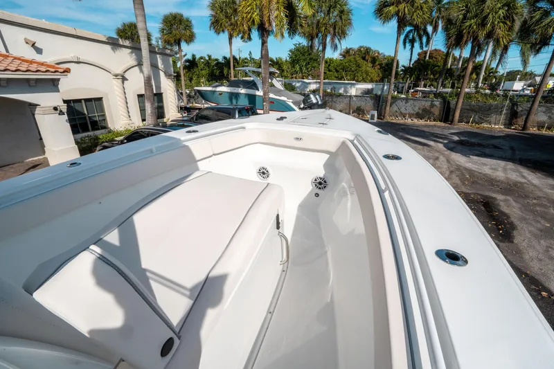 Slide: The Image of 2025 Sea Hunt GAMEFISH 27 CB boat, featuring spacious seating and sleek design, parked outdoors. - 34