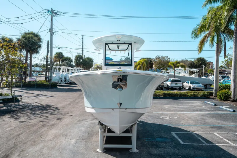 Slide: The Image of 2025 Sea Hunt GAMEFISH 27 CB boat displayed in a sunny parking lot. - 7