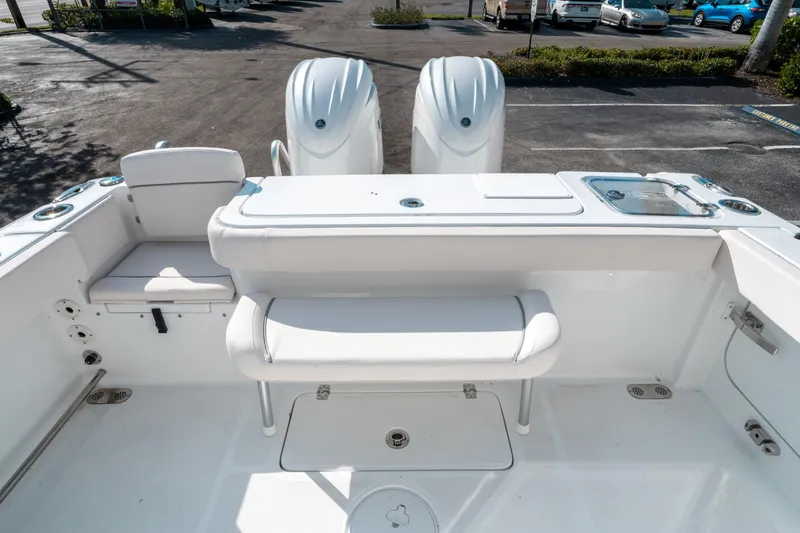 Slide: The Image of 2025 Sea Hunt GAMEFISH 27 CB boat interior with seating and dual engines. - 13