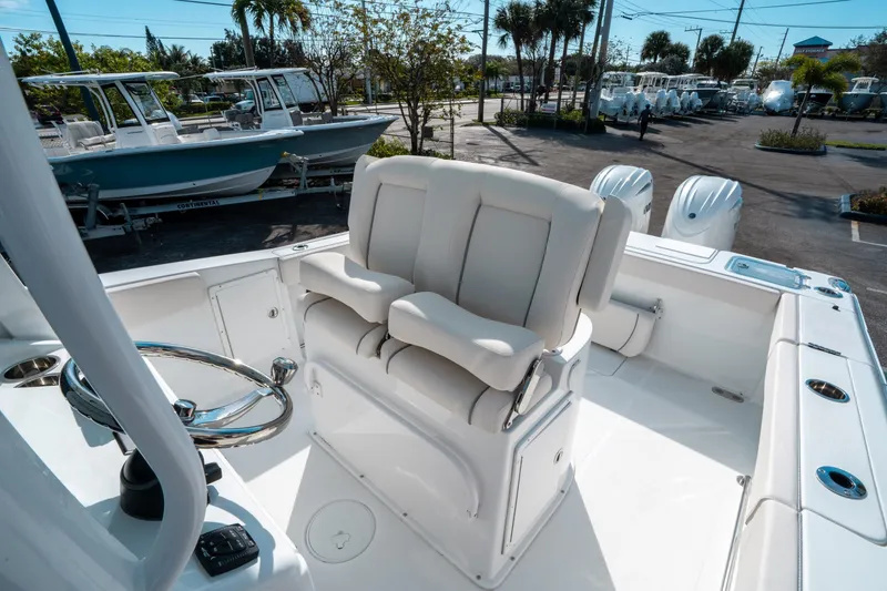 Slide: The Image of 2025 Sea Hunt GAMEFISH 27 CB boat interior with helm and seating. - 27