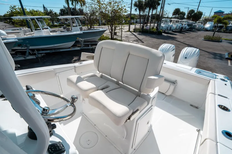 Slide: The Image of 2025 Sea Hunt GAMEFISH 27 CB boat interior with seating and steering wheel. - 29
