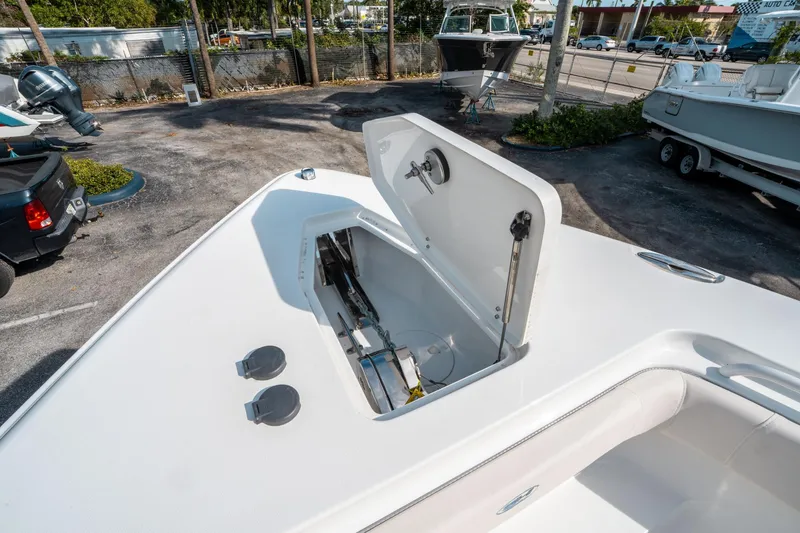 Slide: The Image of 2025 Sea Hunt GAMEFISH 27 CB boat with open storage compartment in a parking area. - 40