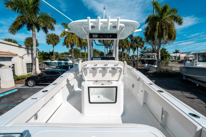 Slide: The Image of 2025 Sea Hunt GAMEFISH 27 CB boat, spacious deck, palm trees in background. - 9
